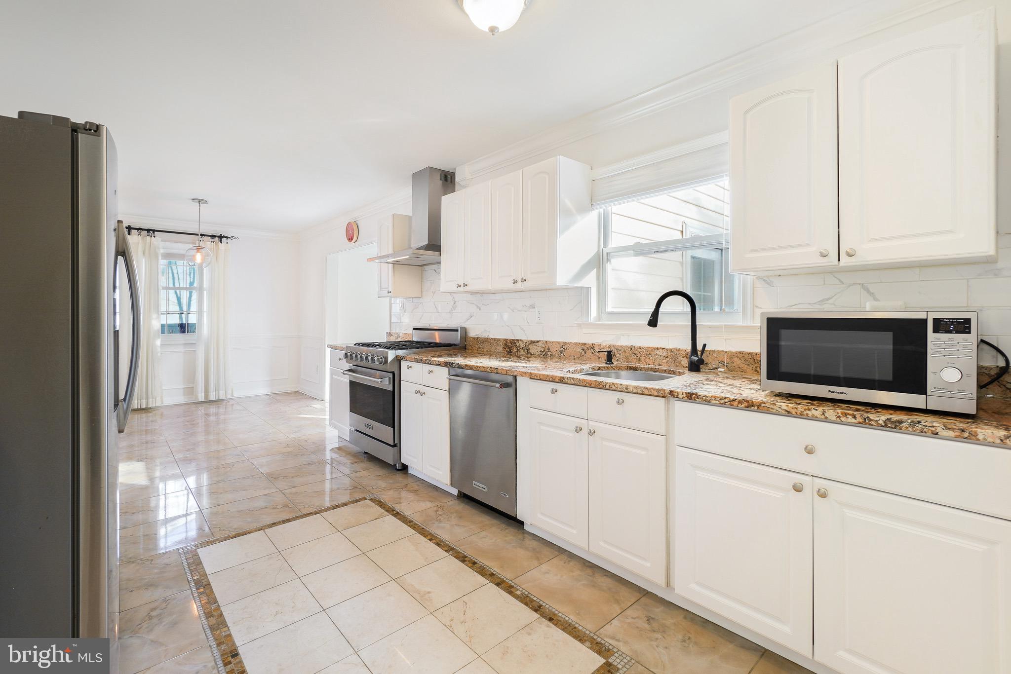 4712 Listra Road Rockville, MD 20853 - Photo 9 of 30 a kitchen with granite countertop a sink stove and refrigerator