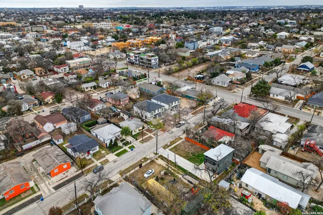 an aerial view of a house with a yard