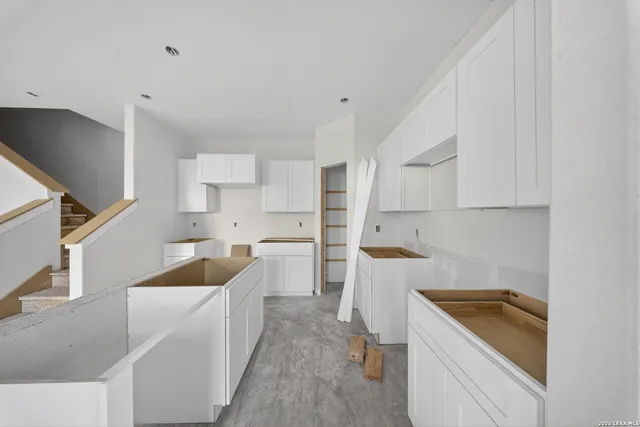 a kitchen with a sink a stove and cabinets