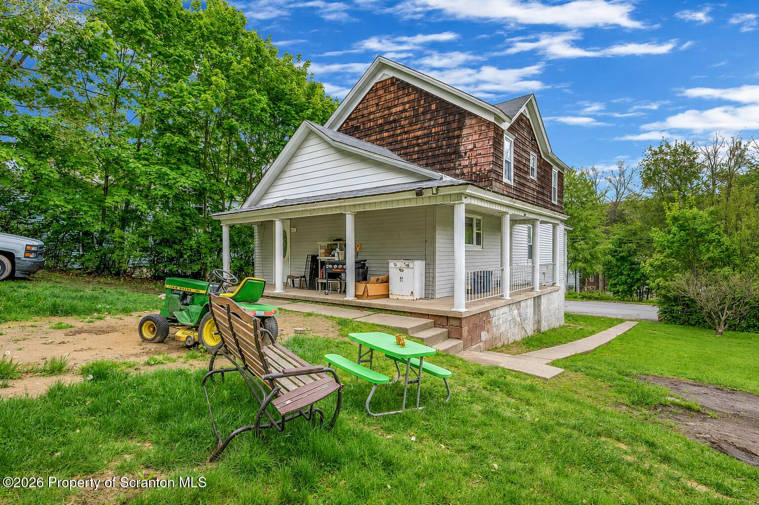29 Rittenhouse Street Simpson, PA 18407 - Photo 6 of 36 a view of a house with backyard sitting area and garden