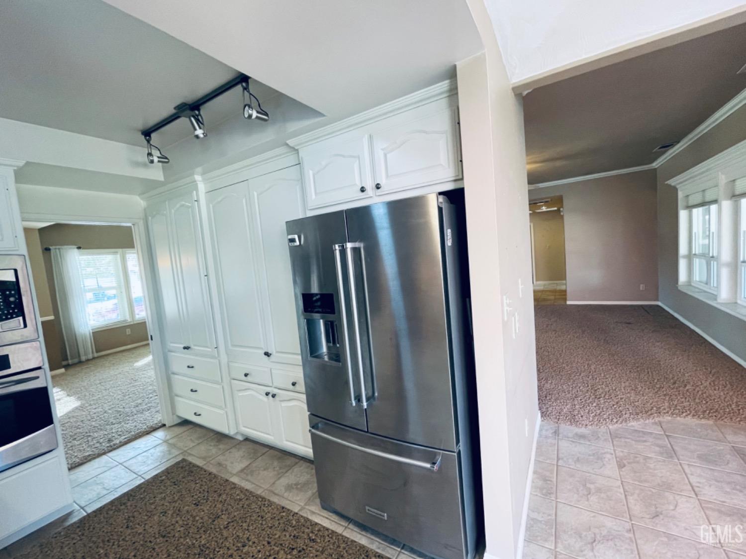 Undisclosed Address Shafter, CA 93263 - Photo 15 of 41 a view of a kitchen with refrigerator and mirror