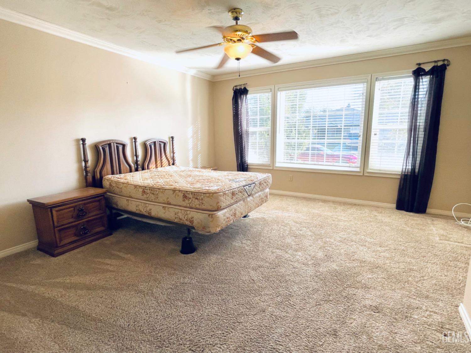 Undisclosed Address Shafter, CA 93263 - Photo 17 of 41 a spacious bedroom with a bed and a chandelier