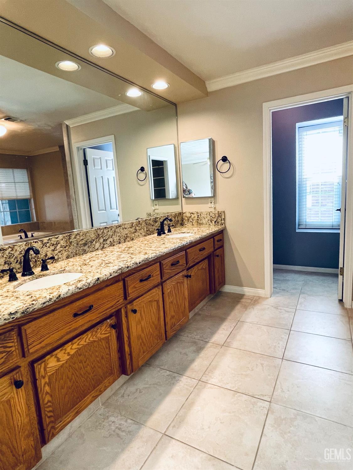 Undisclosed Address Shafter, CA 93263 - Photo 18 of 41 a spacious bathroom with a granite countertop sink a mirror and a bathtub