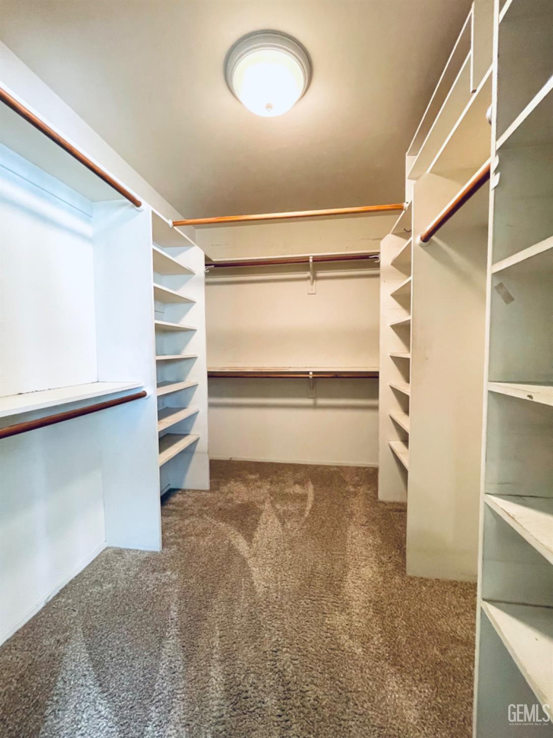 Undisclosed Address Shafter, CA 93263 - Photo 21 of 41 a view of walk in closet with empty racks