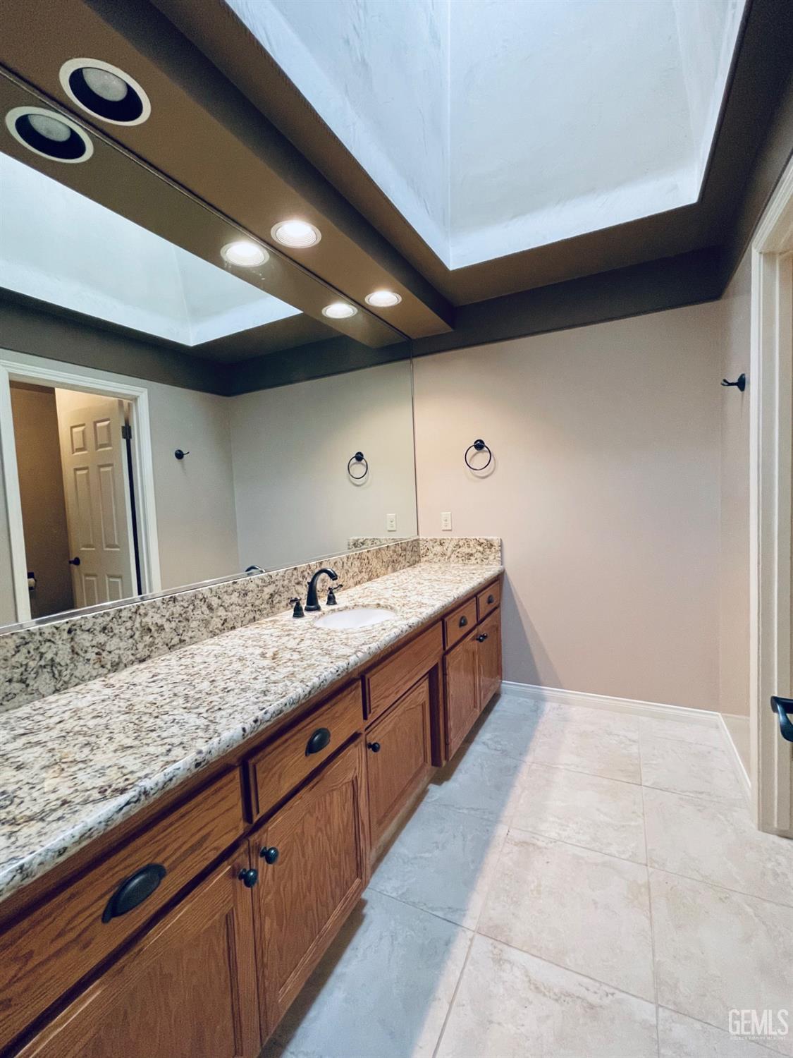 Undisclosed Address Shafter, CA 93263 - Photo 23 of 41 a spacious bathroom with a granite countertop sink and a mirror