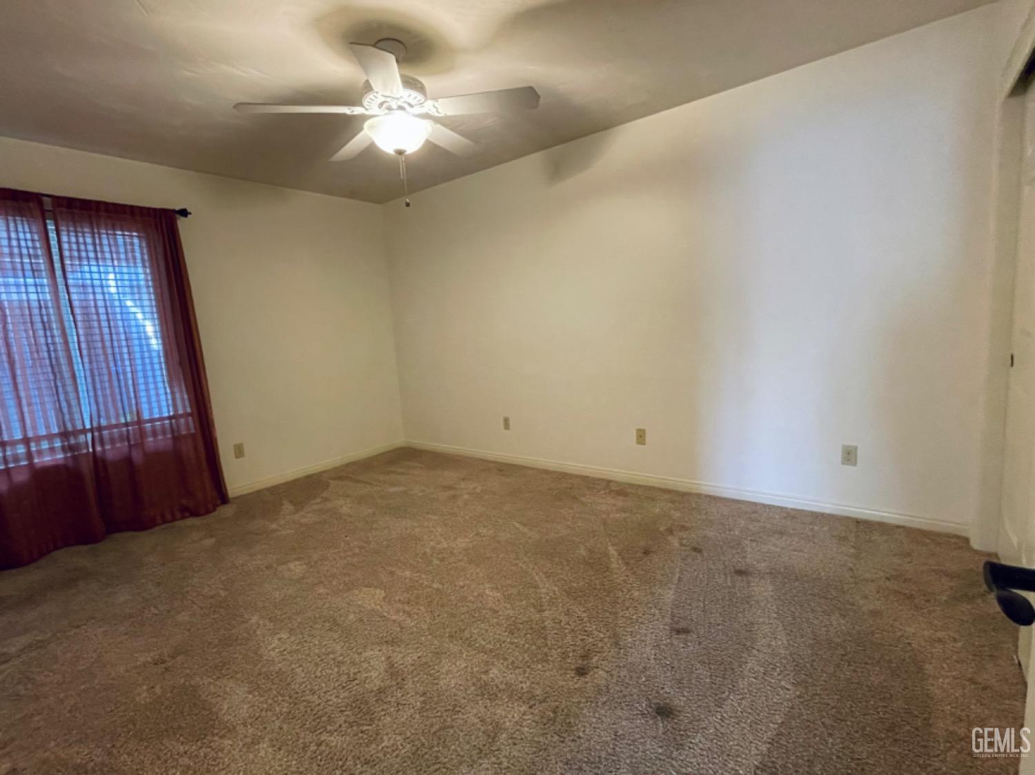 Undisclosed Address Shafter, CA 93263 - Photo 26 of 41 a view of a livingroom with a ceiling fan and window