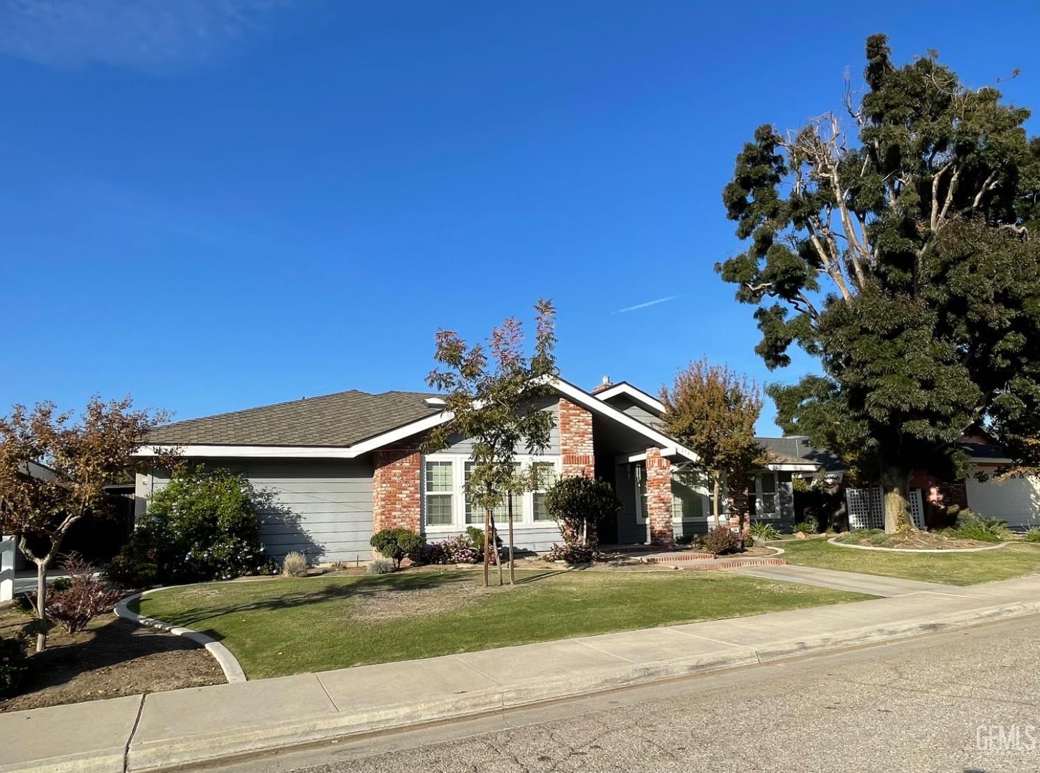 Undisclosed Address Shafter, CA 93263 - Photo 3 of 41 a view of a house next to a yard with big trees