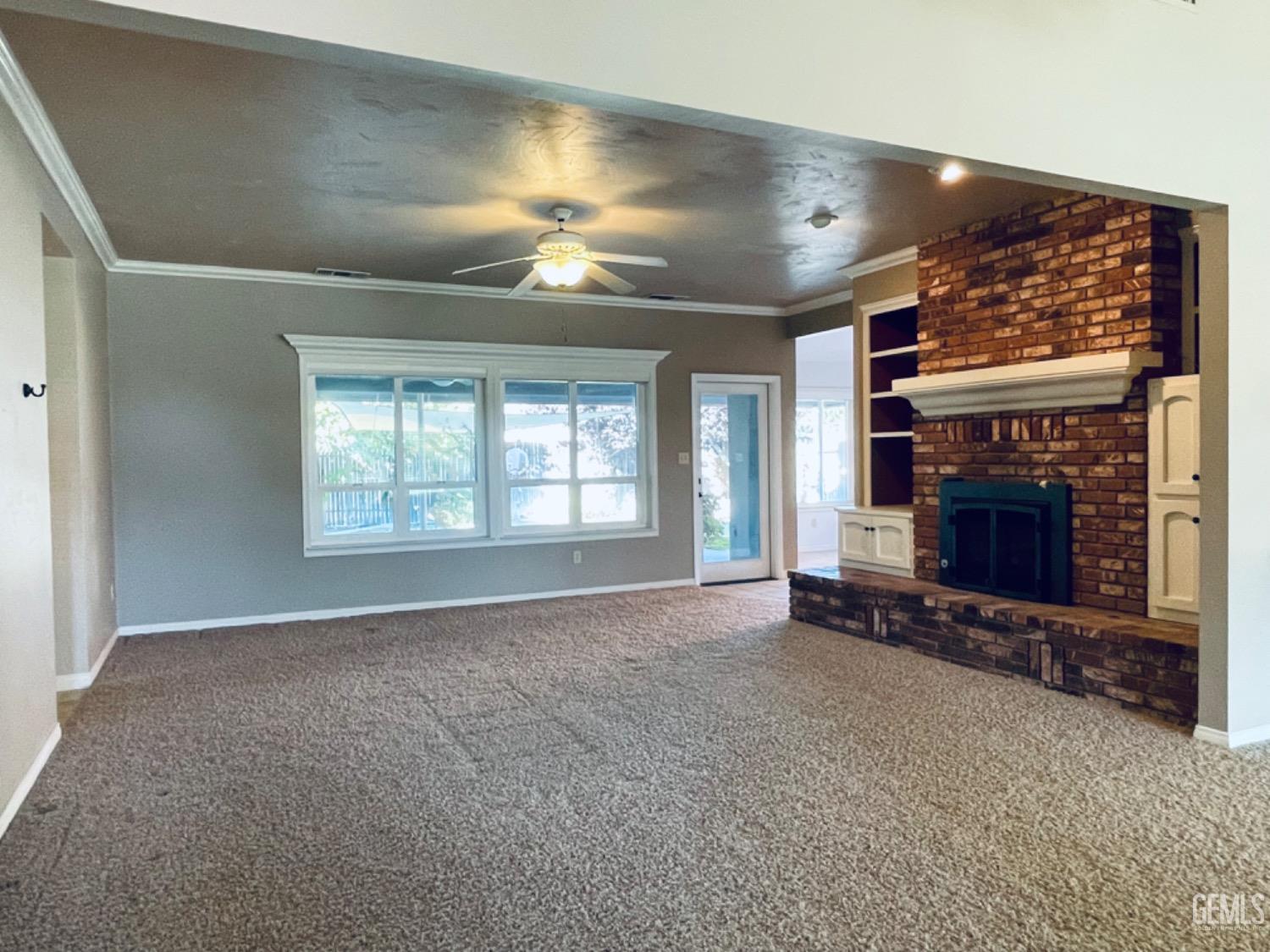 Undisclosed Address Shafter, CA 93263 - Photo 5 of 41 an empty room with windows and fireplace