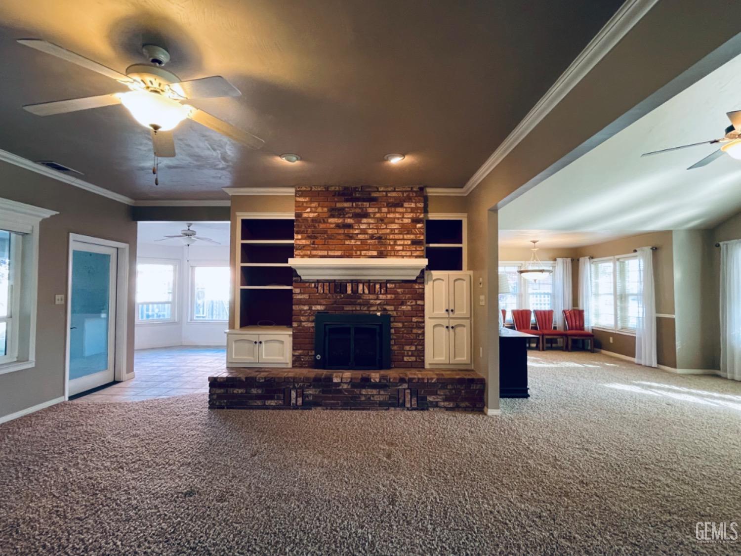 Undisclosed Address Shafter, CA 93263 - Photo 7 of 41 a view of a big room with large windows and a fireplace