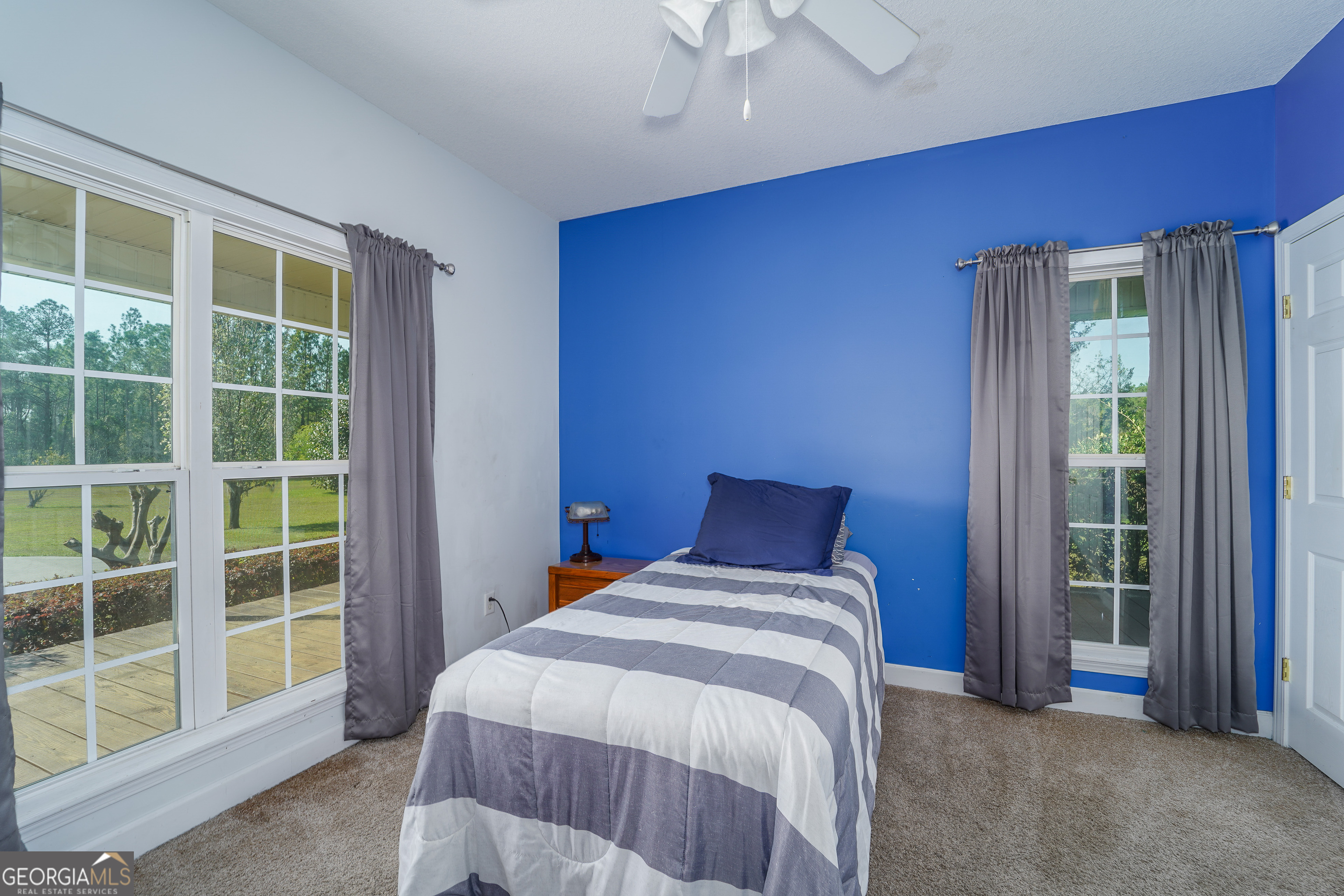 3300 Connor Lane Waycross, GA 31503 - Photo 37 of 42 a bed sitting in a bedroom next to a window