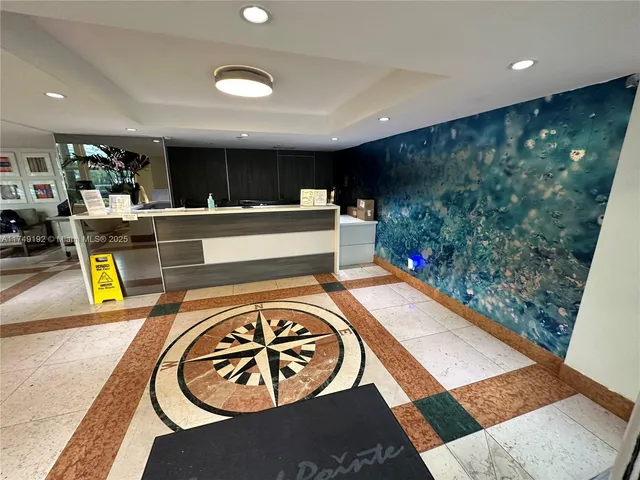 a living room with furniture and large windows