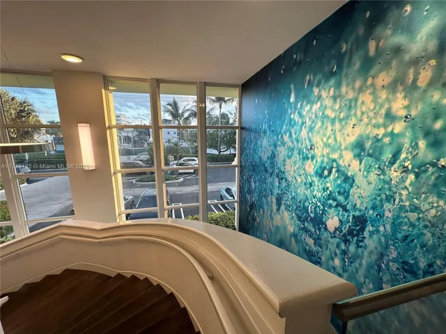 a dining hall with stainless steel appliances granite countertop a refrigerator and a sink