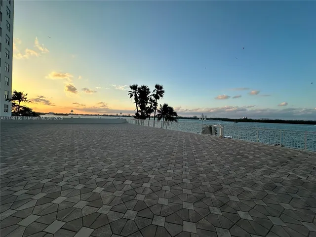 a view of a balcony with wooden floor and fence and city view