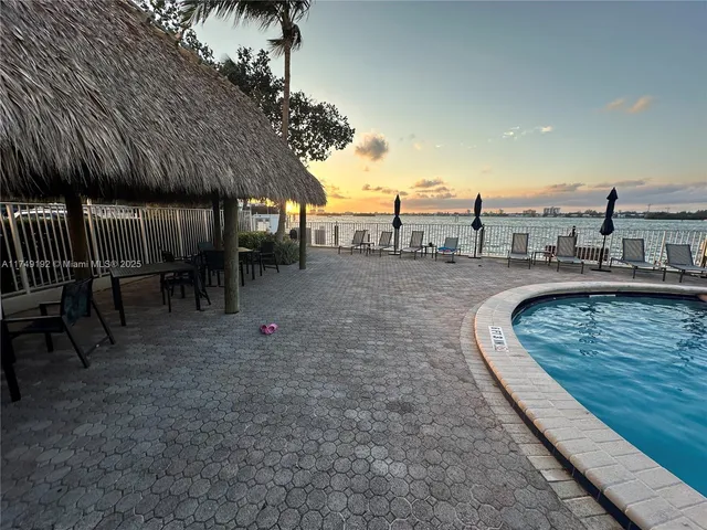 a view of a balcony with wooden floor and lake view