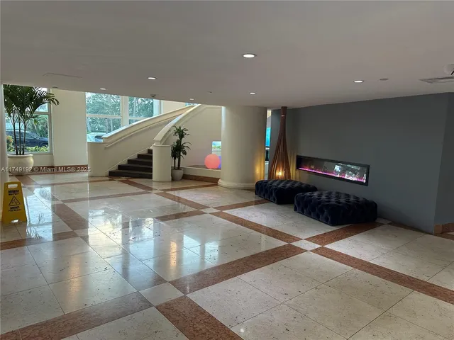 a lobby with a couch and a potted plant