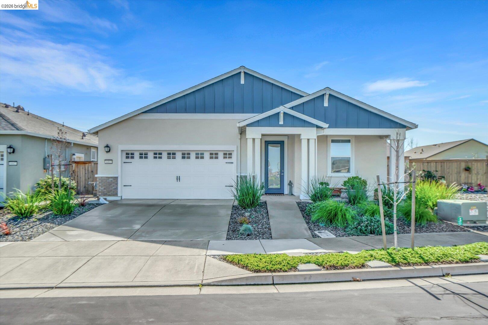 4463 Canada Way Rio Vista, CA 94571 - Photo 13 of 36 view of front facade with driveway, a garage, stucco siding, and brick siding
