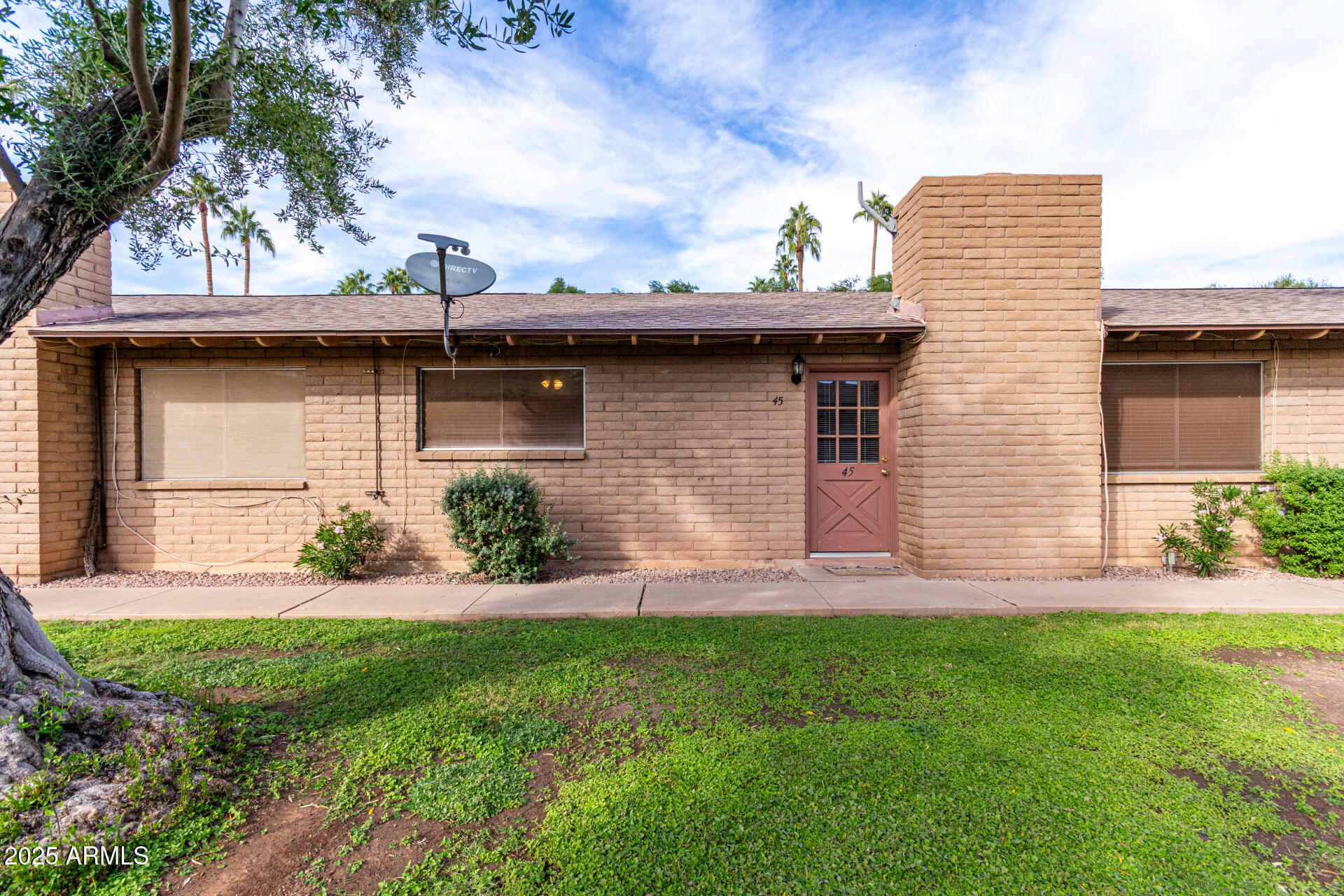 3031 South Rural Road, Unit 45 Tempe, AZ 85282 - Photo 1 of 28 a front view of a house with a yard and garage