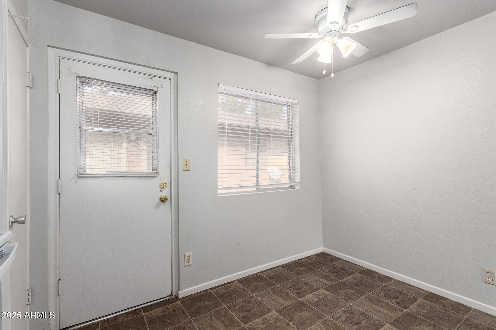 3031 South Rural Road, Unit 45 Tempe, AZ 85282 - Photo 12 of 28 an empty room with windows and fan