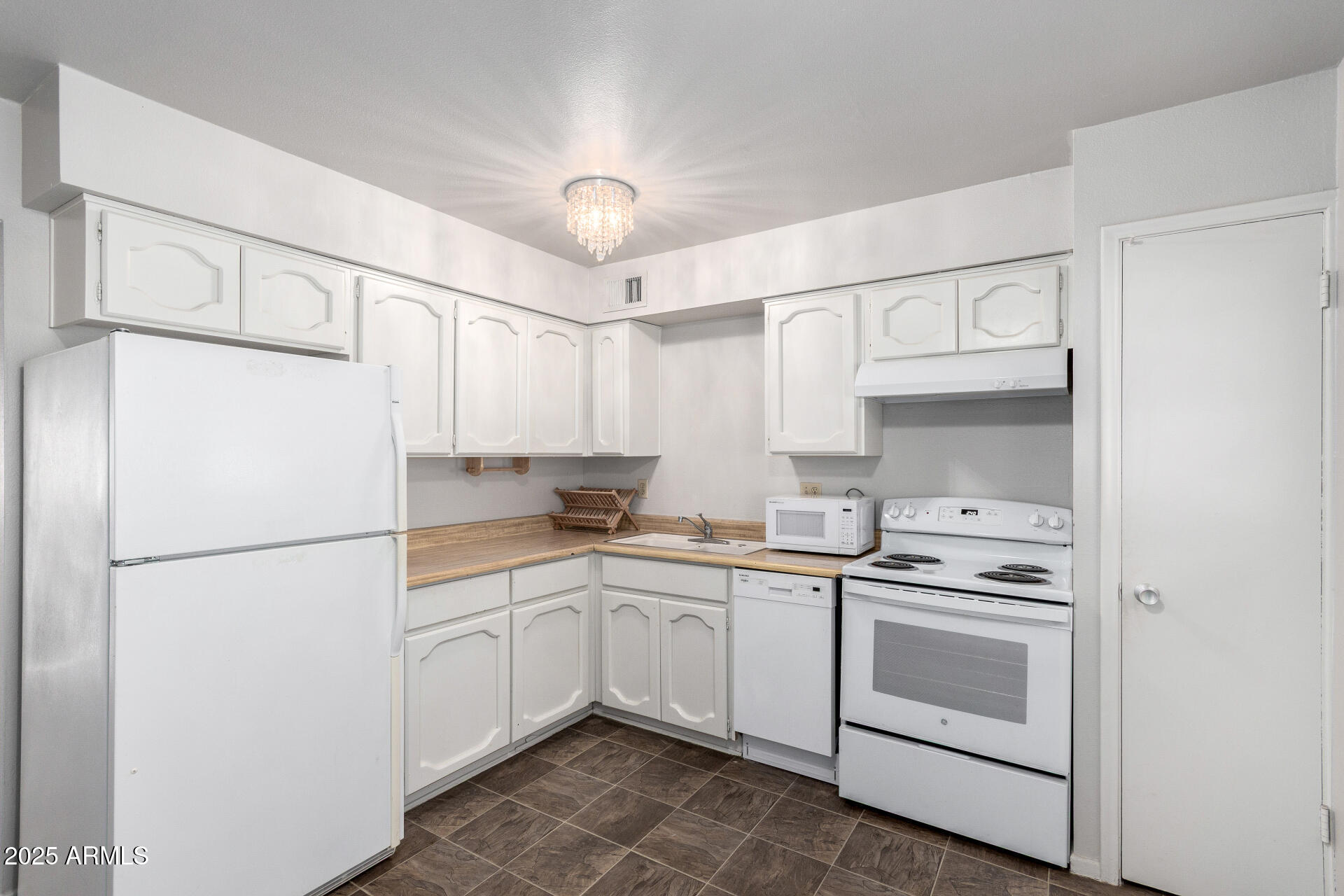 3031 South Rural Road, Unit 45 Tempe, AZ 85282 - Photo 8 of 28 a kitchen with white cabinets and white appliances