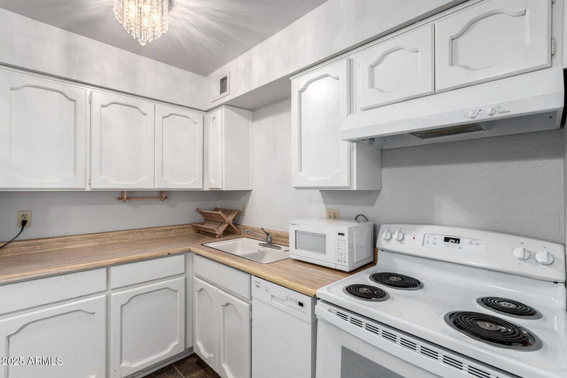 3031 South Rural Road, Unit 45 Tempe, AZ 85282 - Photo 9 of 28 a kitchen with white cabinets and white appliances
