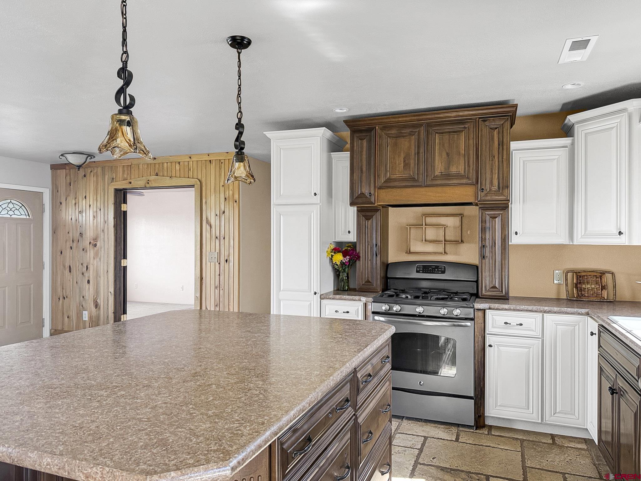 32310 B50 Road Crawford, CO 81415 - Photo 14 of 45 a kitchen with a stove a sink and cabinets