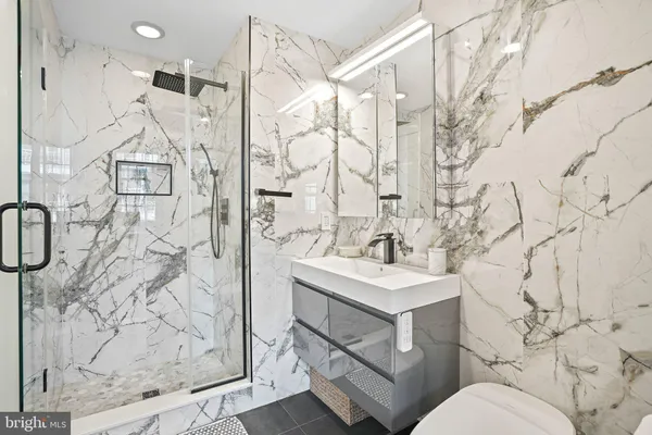 a bathroom with a sink toilet and shower