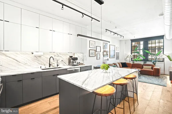 a living room with granite countertop furniture and a floor to ceiling window