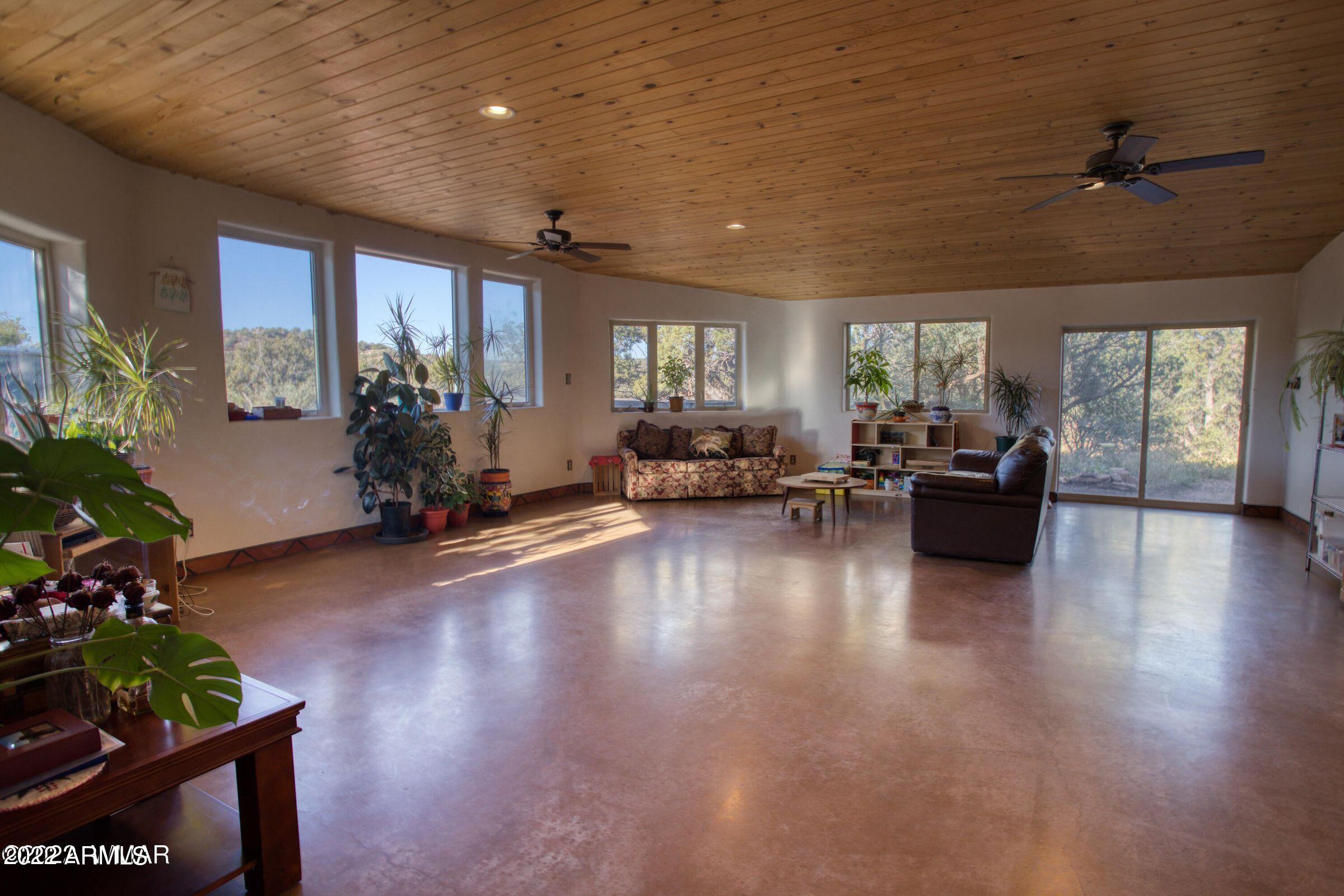 3311 Yellow Rose Road Snowflake, AZ 85937 - Photo 10 of 52 a living room with furniture floor to ceiling window and wooden floor