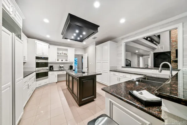 a kitchen with stainless steel appliances granite countertop a stove and a sink