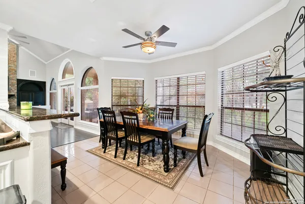 a dining room with furniture a flat screen tv and a large window