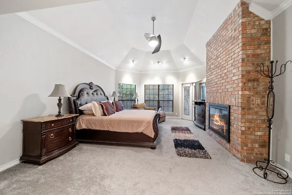 a bedroom with bed and a fireplace