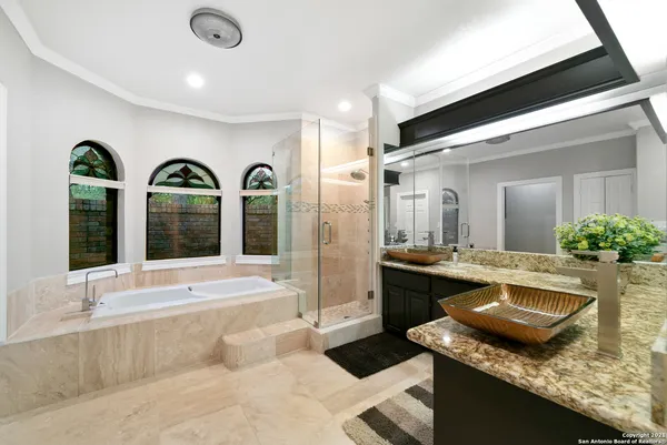 a living room with stainless steel appliances granite countertop sink couches and chandelier