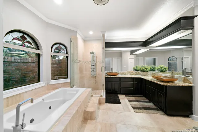 a large white bathroom with a large tub and sink