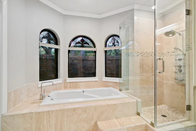 a bathroom with a double vanity sink and large mirror