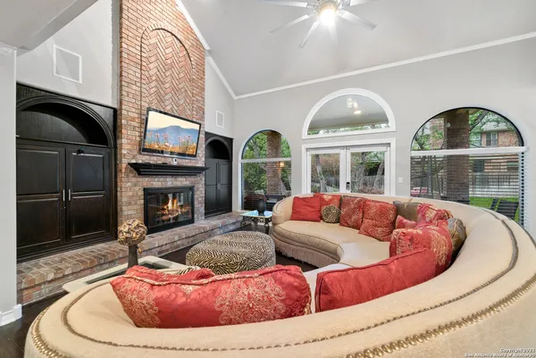 a living room with furniture fireplace and flat screen tv