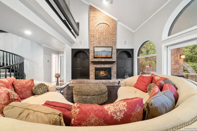 a living room with furniture fireplace and a large window