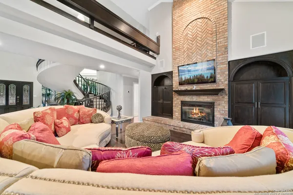 a living room with furniture a fireplace and a flat screen tv