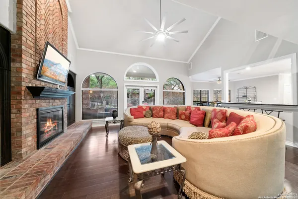 a living room with fireplace furniture and a large window