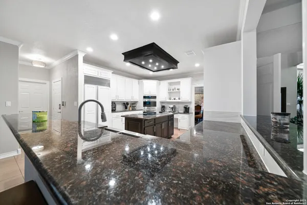 a kitchen with sink refrigerator and stove