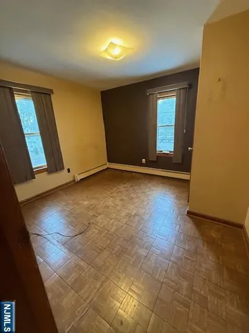 a bedroom with bed and window