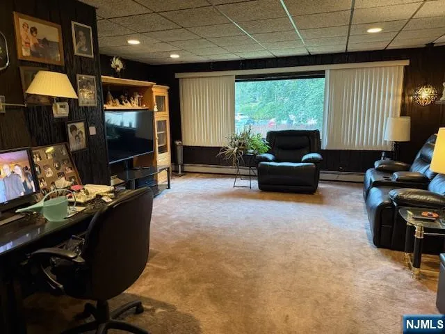 a view of a house with a yard and fence