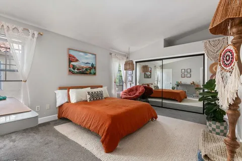 a bedroom with a bed and a couch