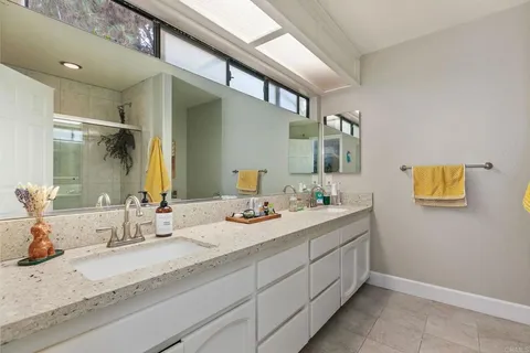 a bathroom with 2 sink and a mirror