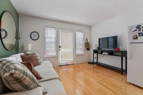 a bedroom with a bed and flat screen tv