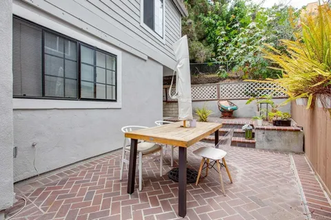 a backyard of a house with table and chairs