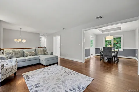 a view of a dining room with furniture wooden floor and chandelier