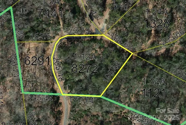 a view of a green field with lots of bushes