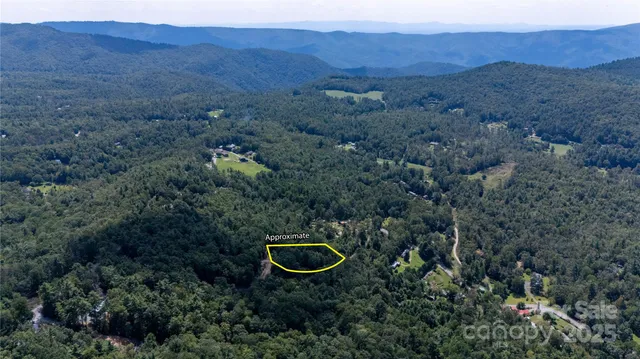 a aerial view of a house with a backyard