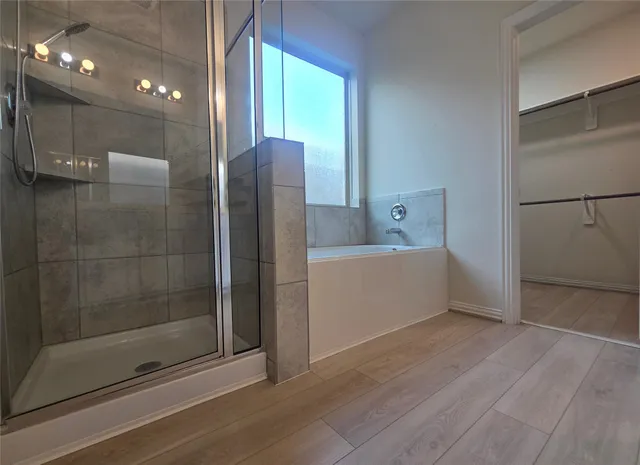 a bathroom with a shower and a sink