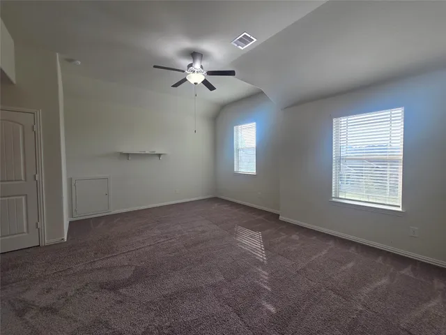 an empty room with windows and closet